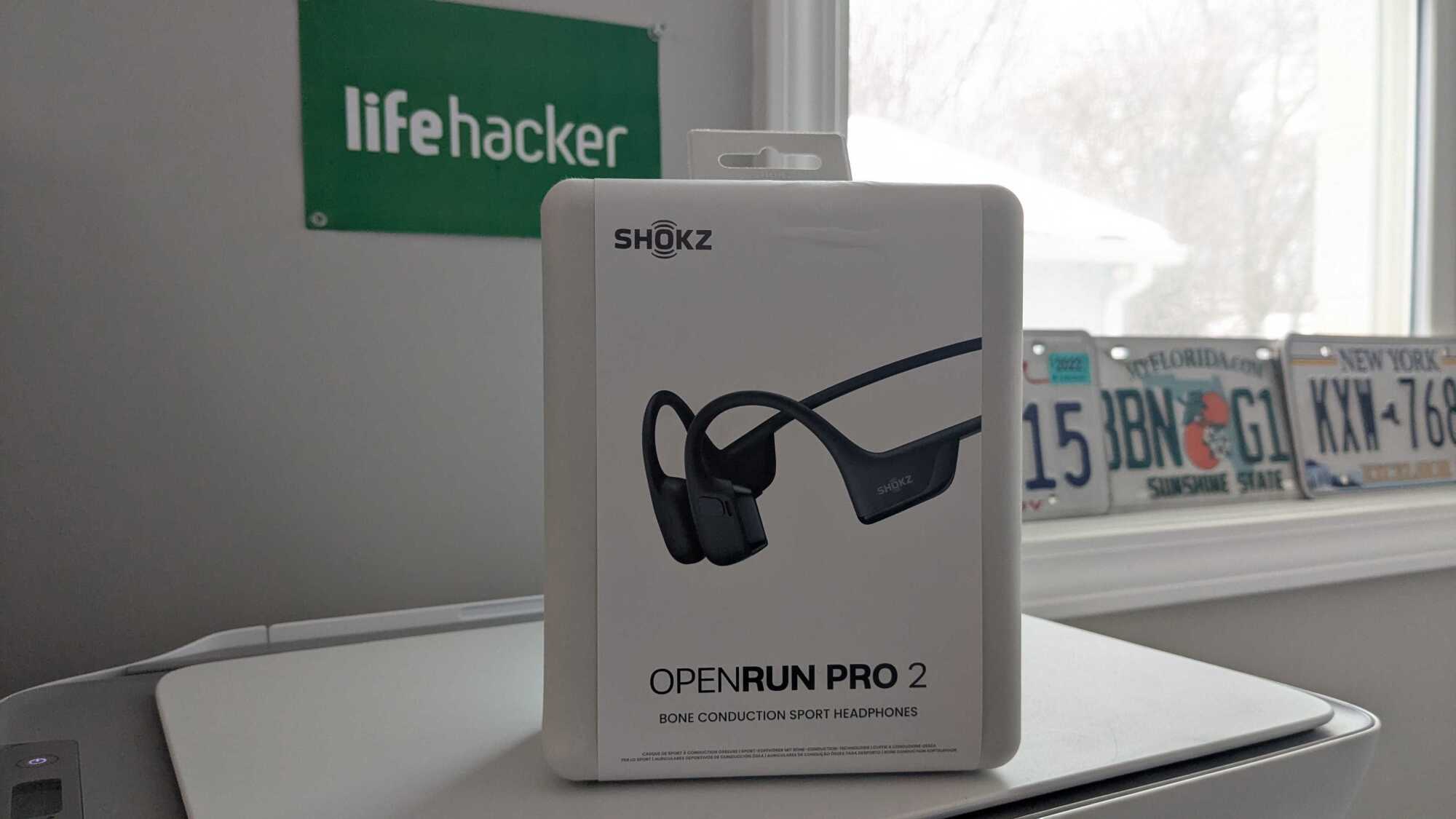The Shokz OpenRun Pro 2 in its original package on top of my printer.