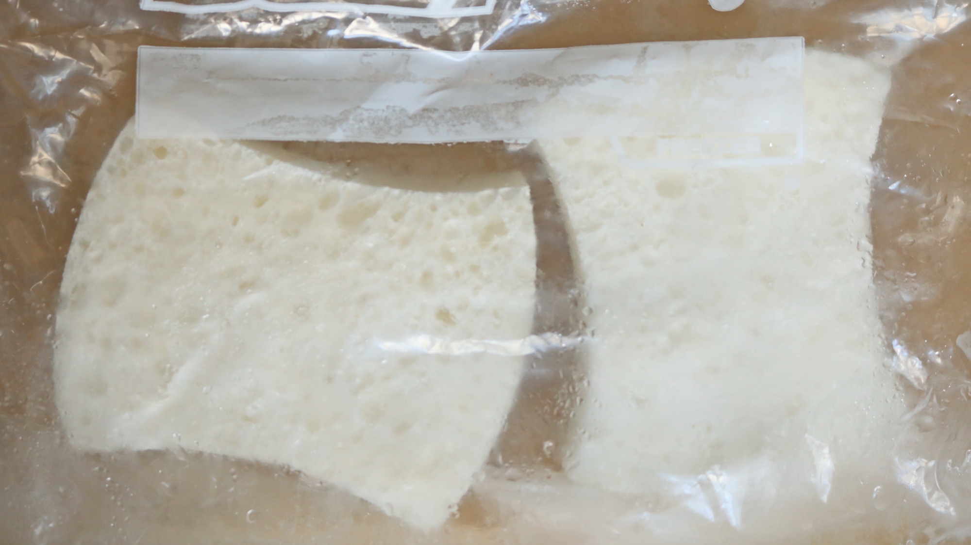 Two frozen sponges in a freezer bag.