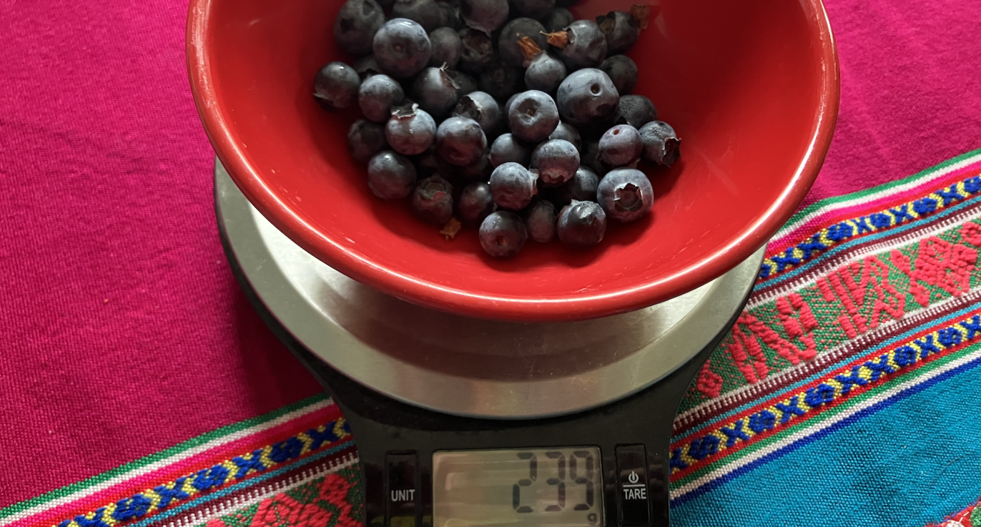 Blueberries on a traditional kitchen scale.